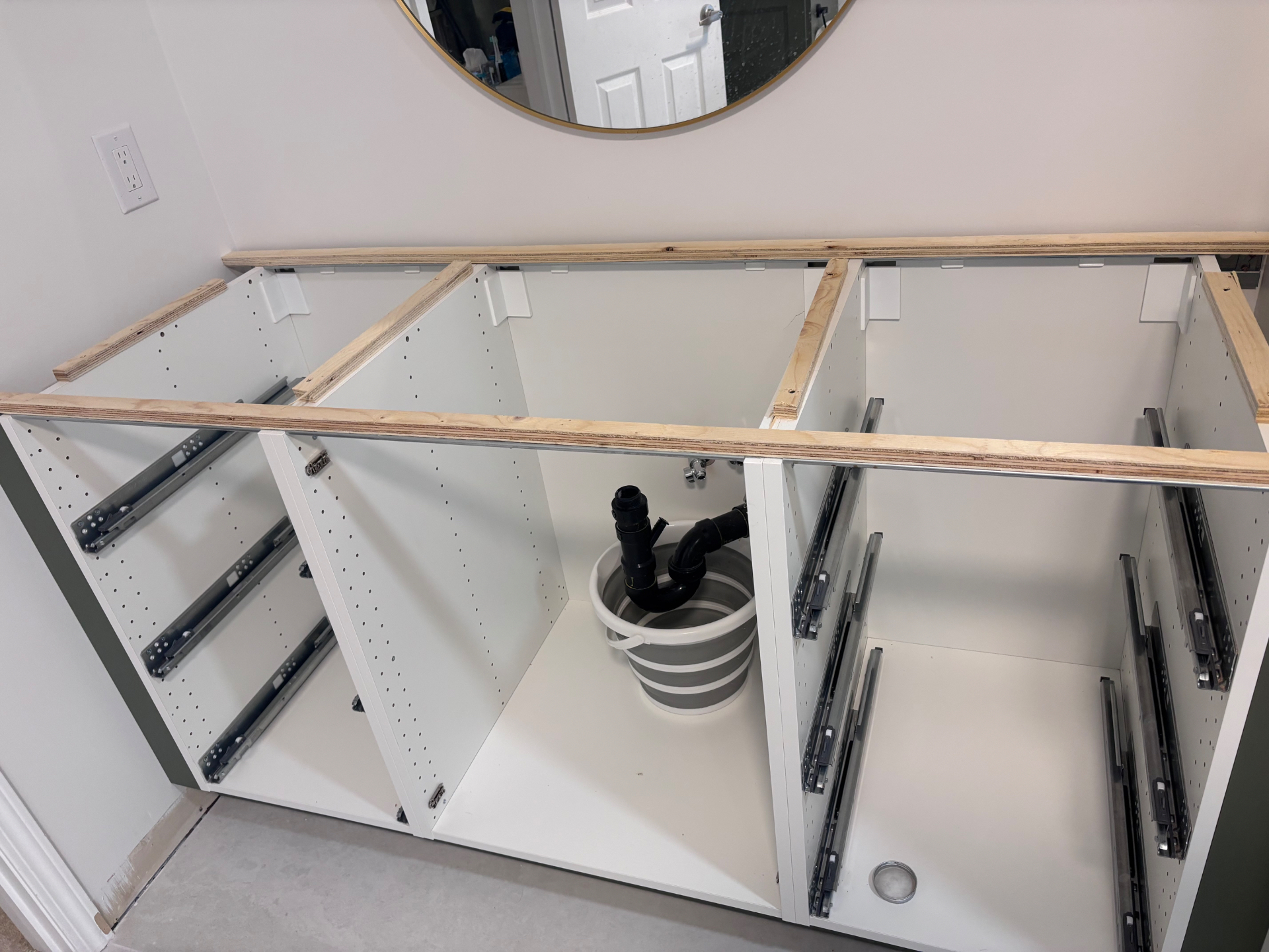 Before: The vanity cabinets and plumbing were prepared for a made to fit replacement top. in Oakville, Ontario