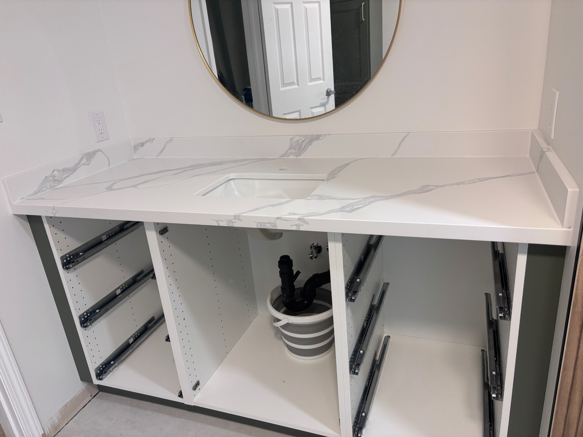 After: A marble look vanity top, integrated sink and matching backsplash were fitted neatly in place. in Oakville, Ontario