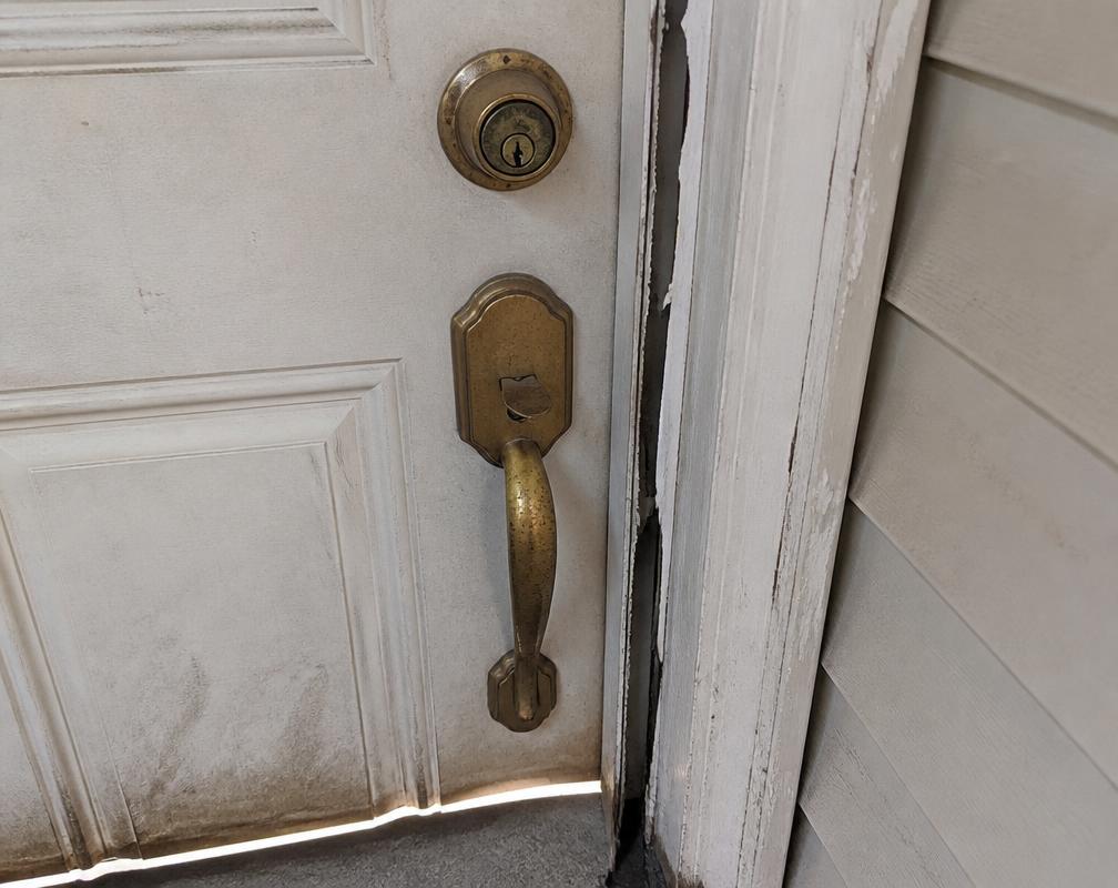 Before: A sticking door with a worn handle and a cold draft. in Old Oakville
