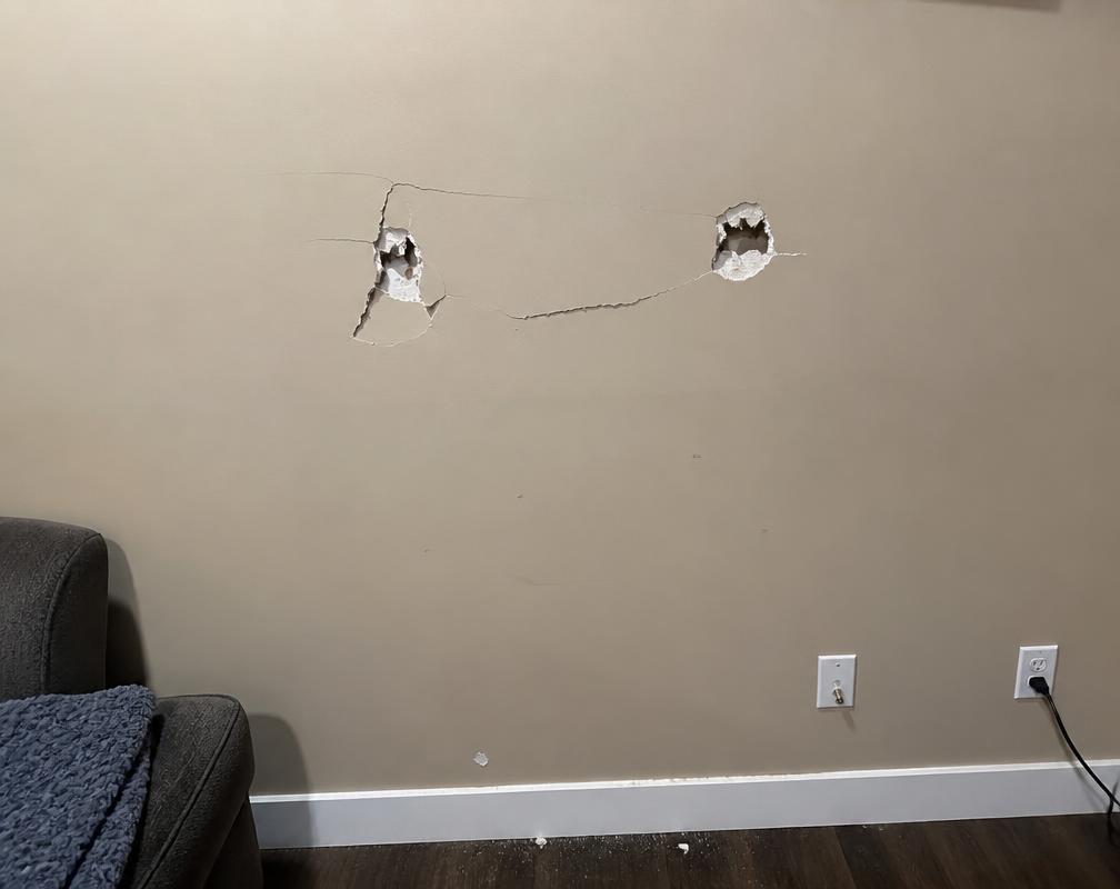 Before: A cracked, dented wall left behind after a mounted TV came down. in Bronte, Oakville